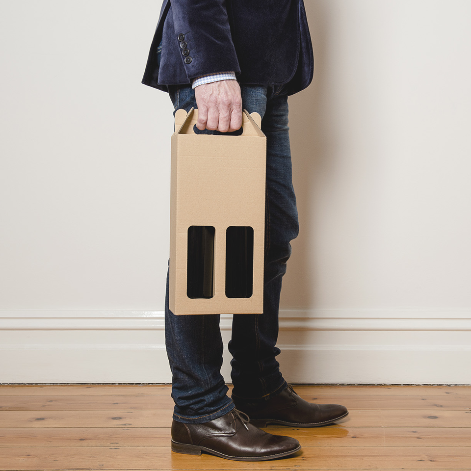 Image of man holding cardboard wine carton