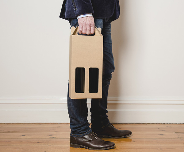 Image of man holding cardboard wine bag