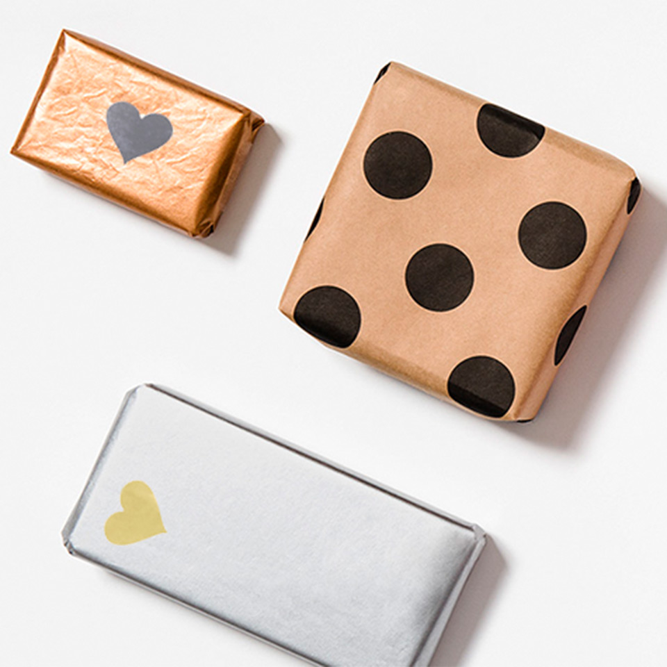 Image of kraft and silver wrapped gifts with heart labels by PaperPak