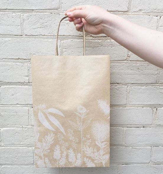 Image of PaperPak Matilda Bag being held up with gum tree design